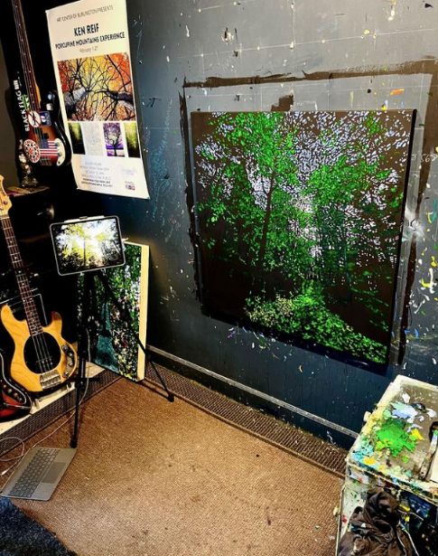 Photo of chicago area artist Ken Reif's studio. There's a guitar in the corner and a nature themed oil painting on the wall